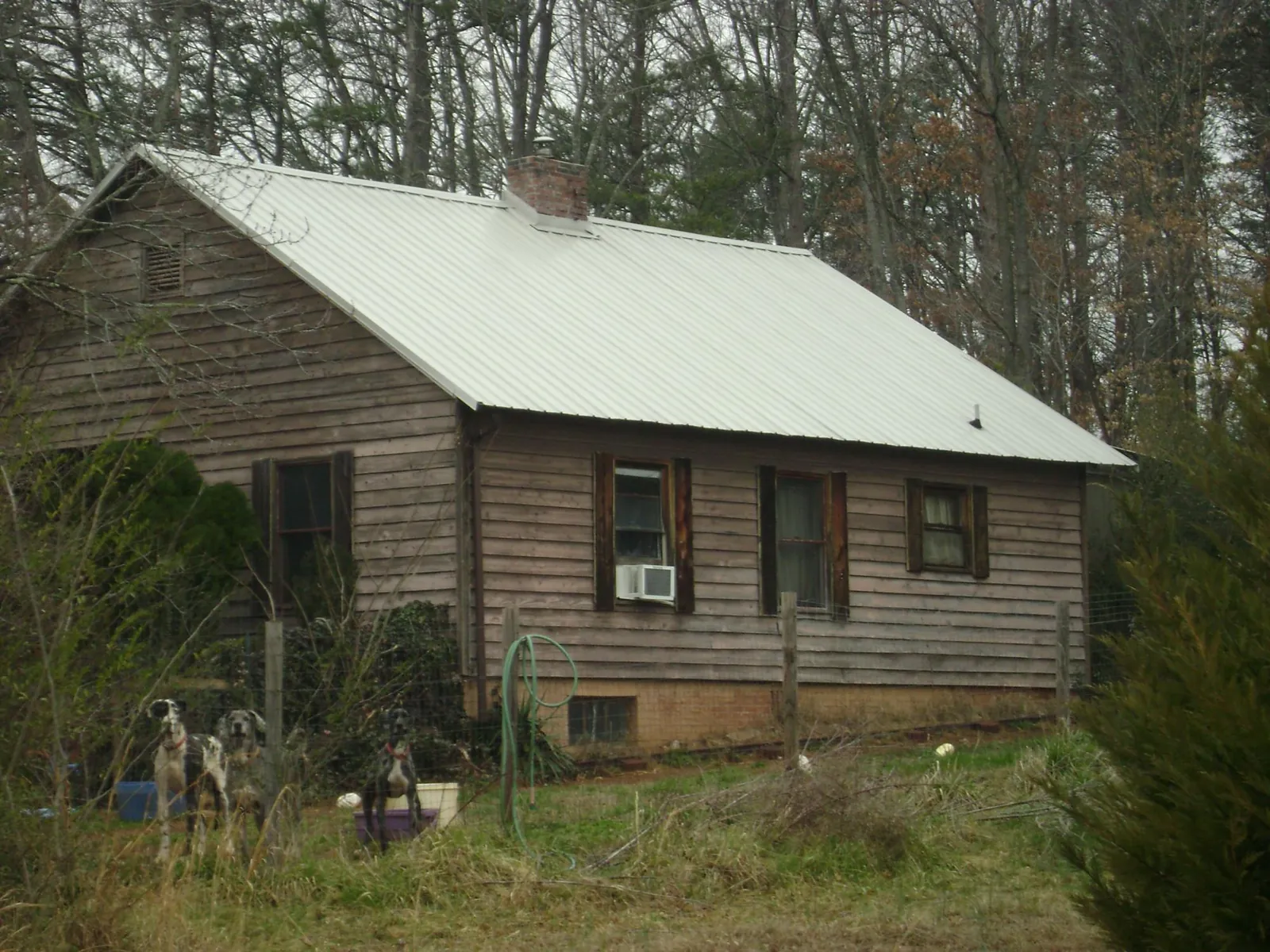 White metal roof on an old wood sided farmhouse, from a Metal Roof Installation job in Sherrard